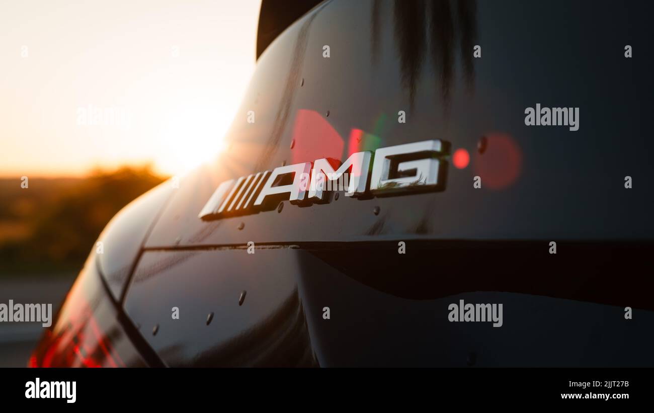 https://c8.alamy.com/comp/2JJT27B/a-closeup-shot-of-a-mercedes-benz-amg-logo-on-a-black-car-against-a-blurred-background-2JJT27B.jpg