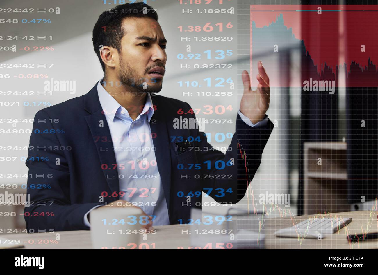 Stressed and angry businessman, trading on the stock market during a financial crisis. Trader in a bear market with stocks crashing showing red Stock Photo