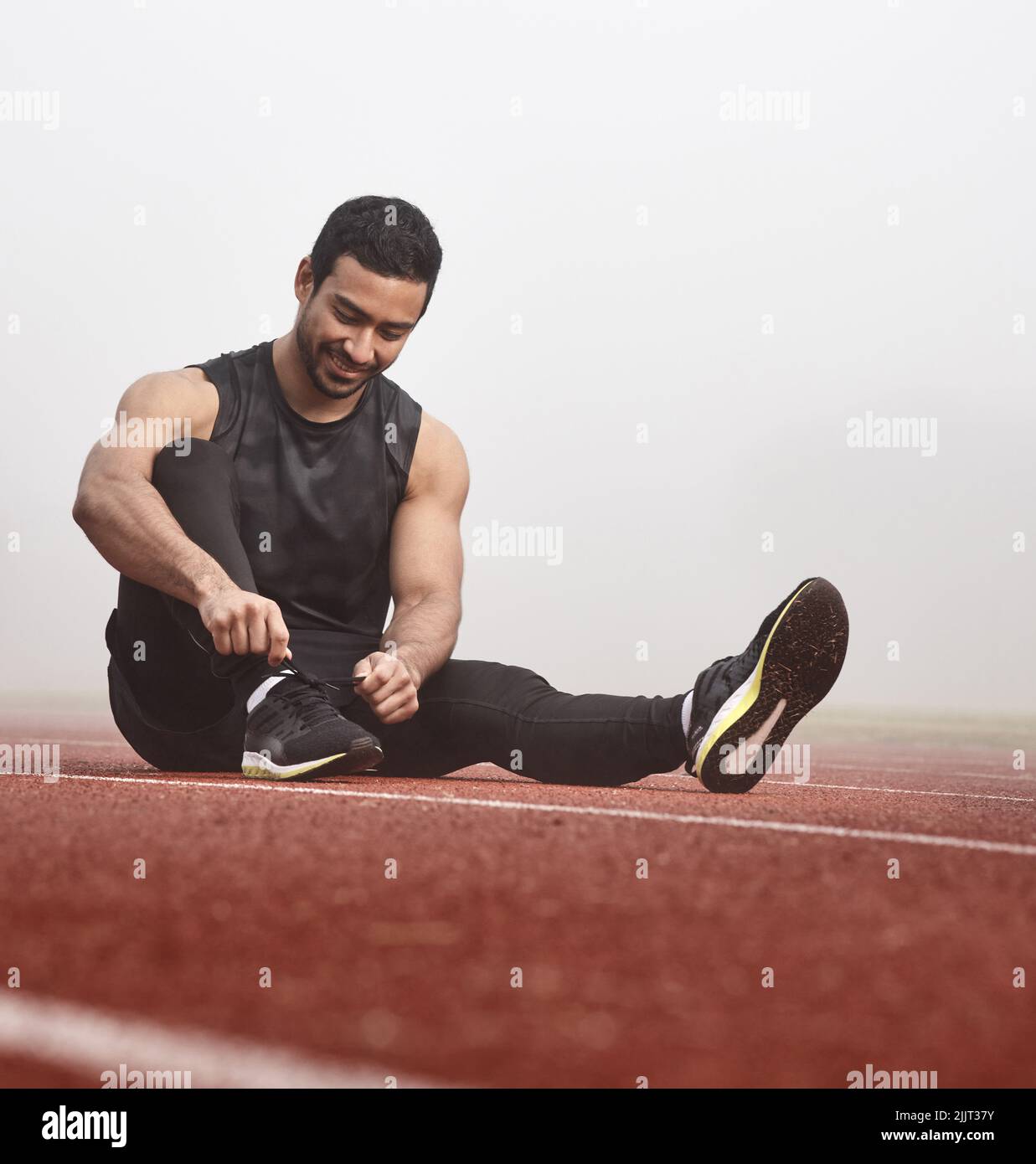 View of Made for endurance and performance. a young male athlete tying his shoe ...