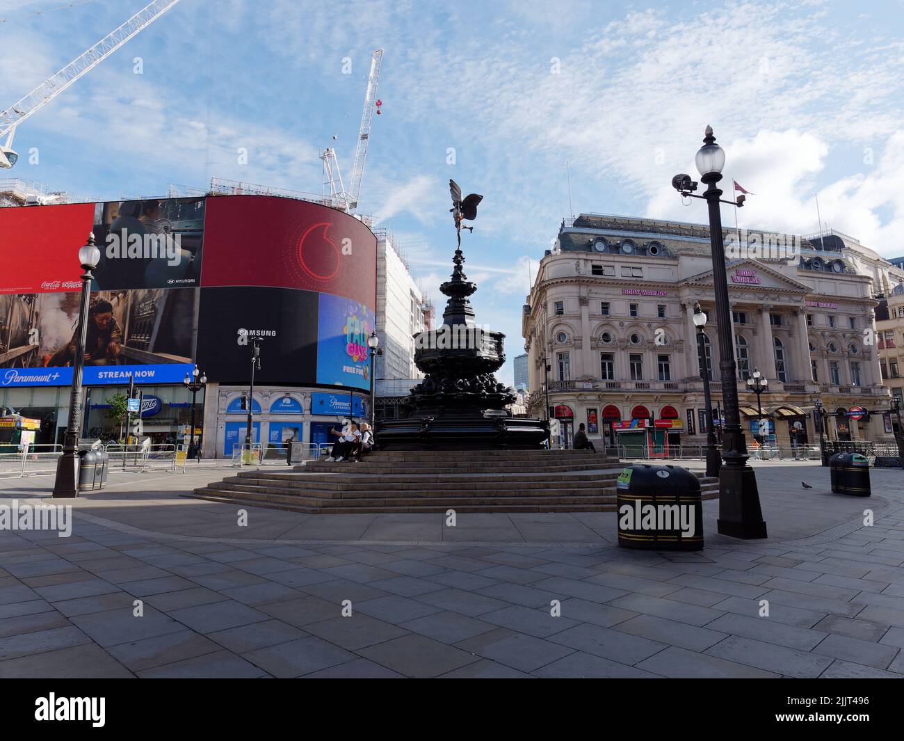 London, Greater London, England, July 02 2022: Almost empty Piccadilly Circus with a few people sitting on the steps of the Shaftesbury Memorial Fount Stock Photo