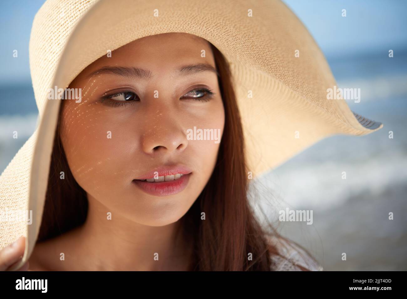 Face Of Pretty Asian Young Woman Wearing Straw Hat On The Beach Stock