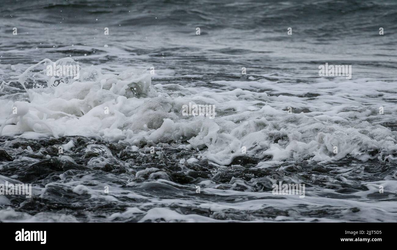 A natural view of big waves hitting the rock in the seashore Stock ...