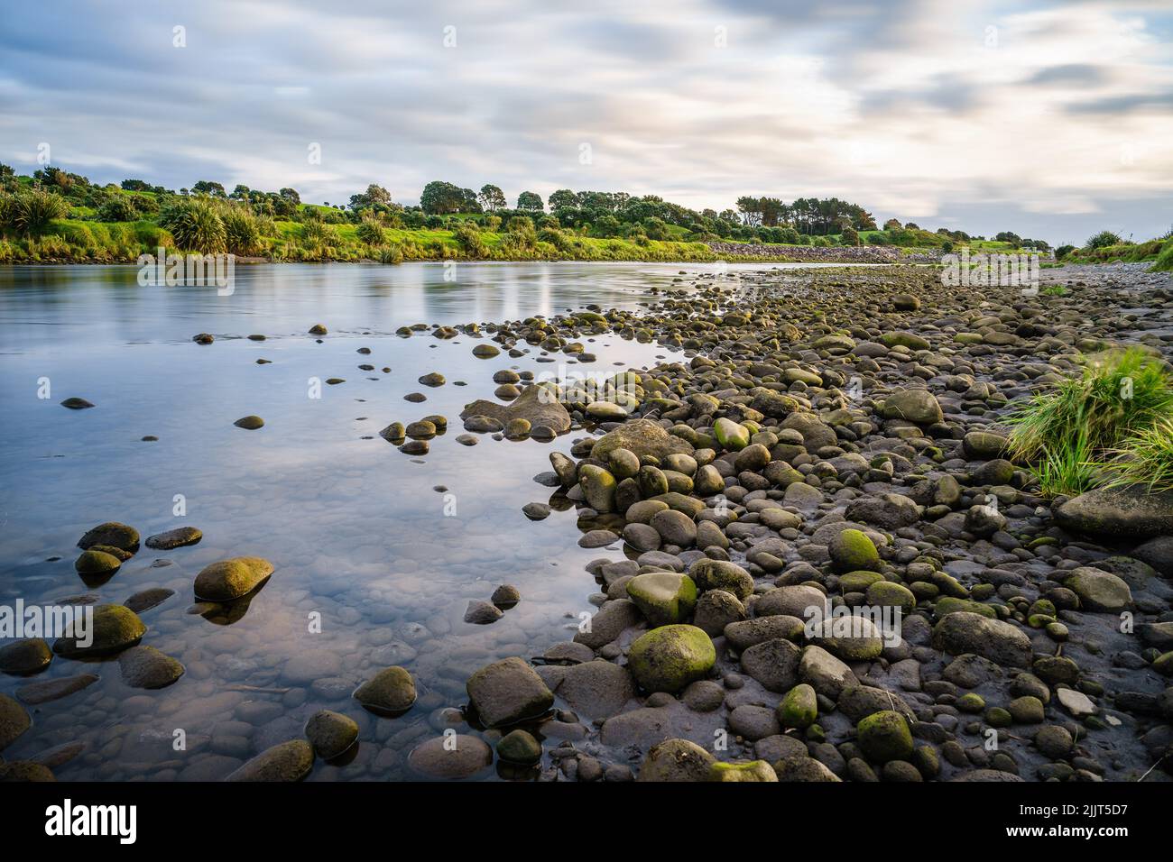 A beautiful view of the river filled with big rocks in New Plymouth, New Zealand Stock Photo