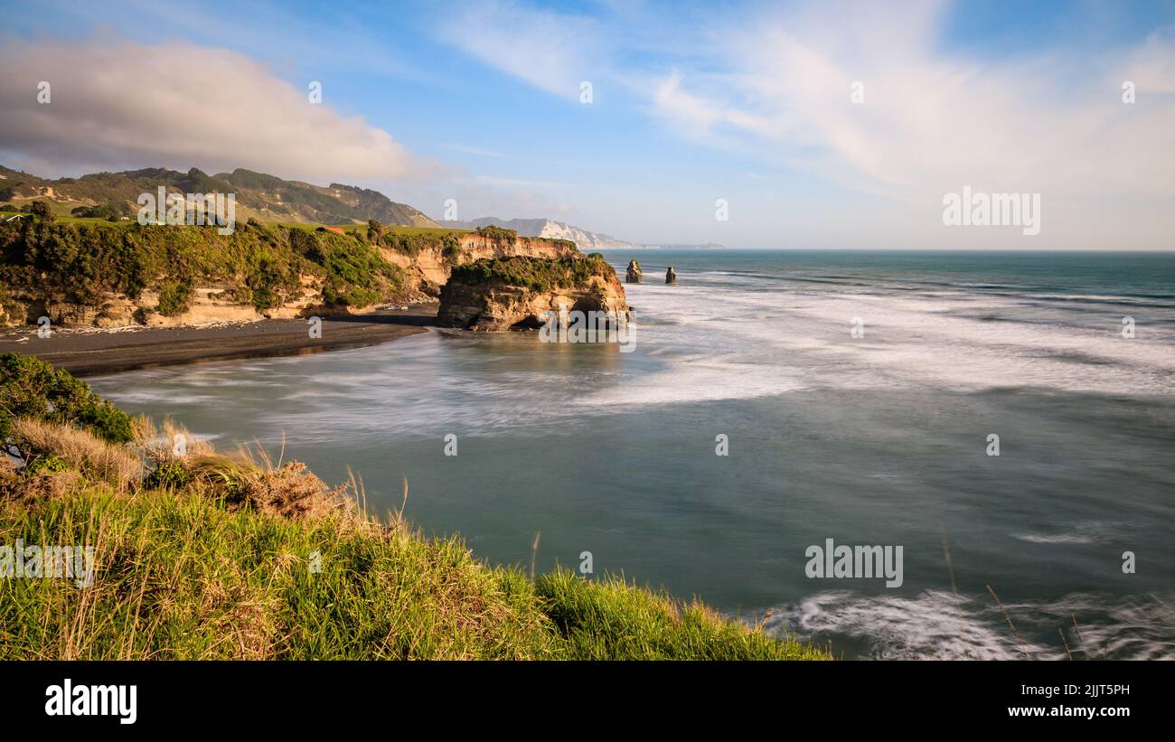 A natural view of cliff and sea in Three Sisters and the Elephant Rock,  New Zealand Stock Photo