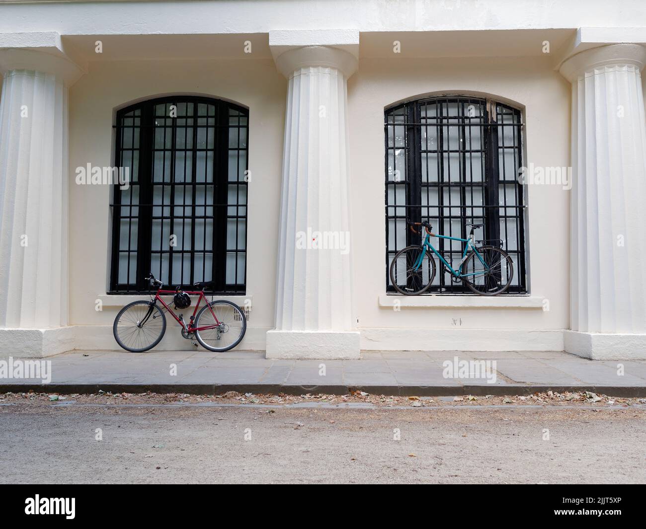 London, Greater London, England, June 30 2022: Red and Blue bicycles parked along The Mall by a window Stock Photo