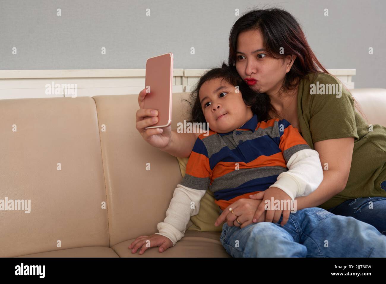 Filipino mother and son taking funny selfies Stock Photo