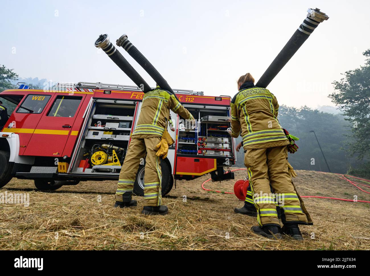 Schmilka, Germany. 28th July, 2022. Firefighters work on the banks of