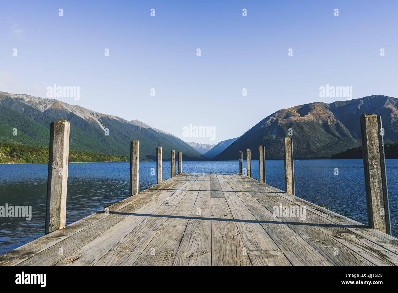 A wooden dock over the water in Nelson Lakes National Park in New Zealand Stock Photo