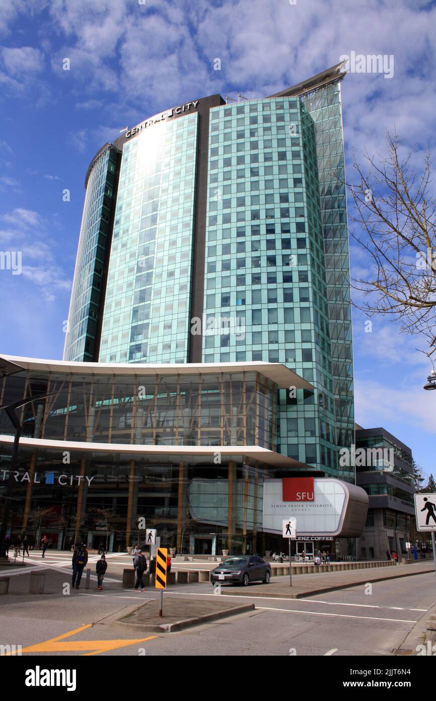 A vertical shot of Central Surrey mall and office building against blue cloudy sky on a sunny day in British Columbia, Canada Stock Photo