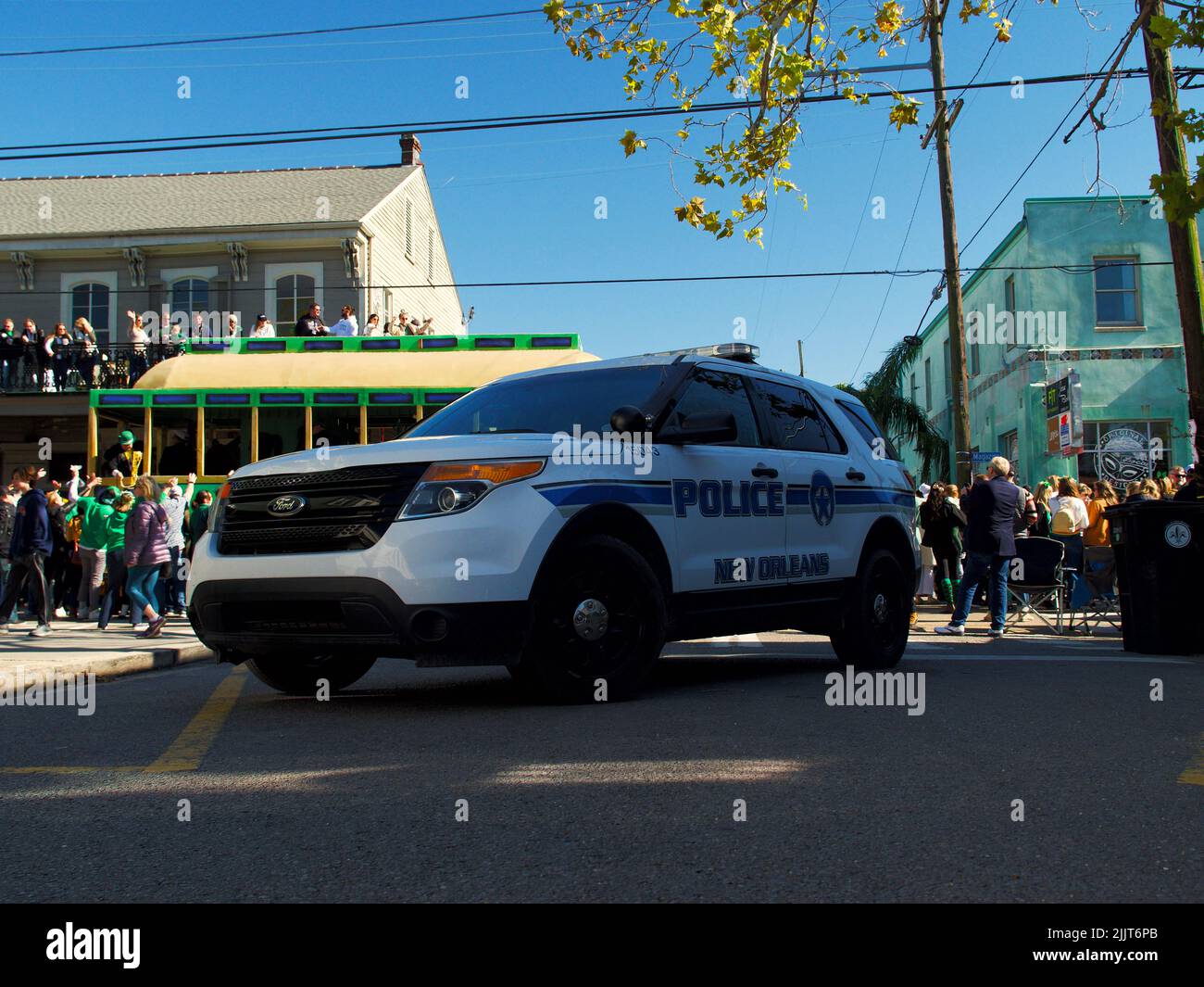 A NOPD patrol vehicle blocks an intersection at the Irish Channel St. Patrick's Day Parade in New Orleans, United States Stock Photo