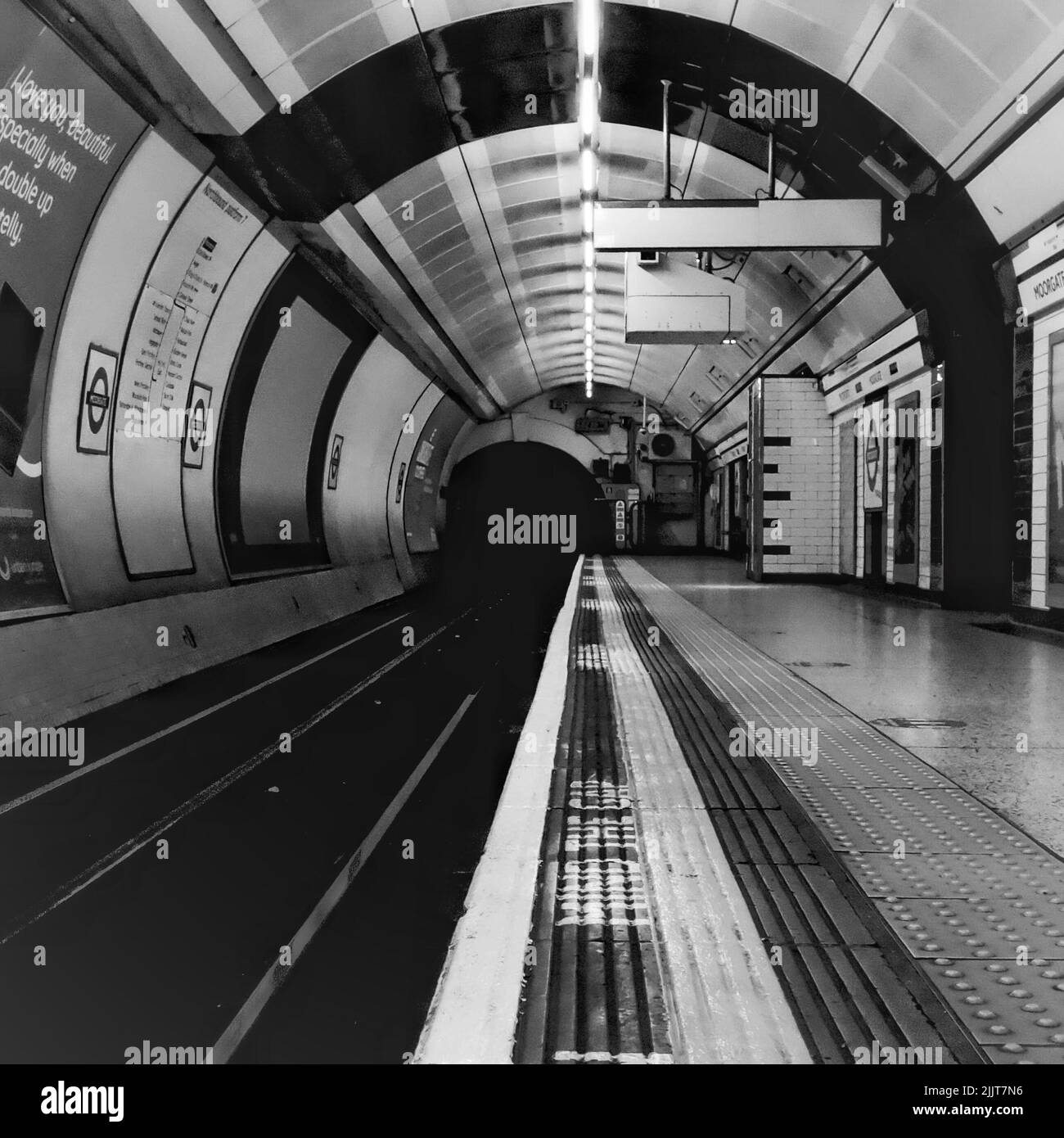 A grayscale shot of London Underground Tube Station tracks Stock Photo