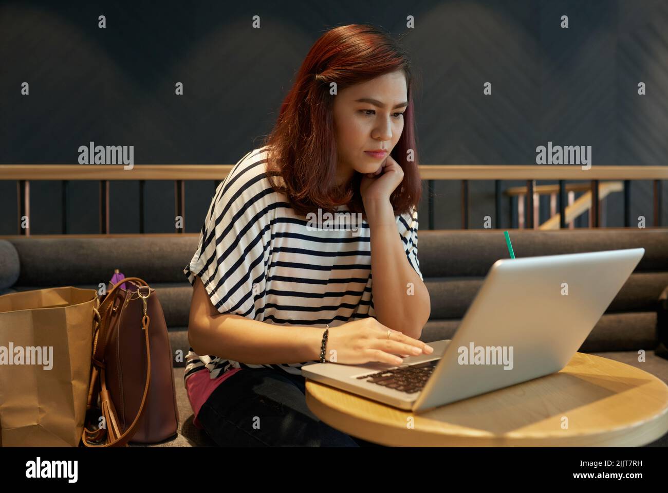 Vietnamese young woman working on laptop in cafe Stock Photo Alamy