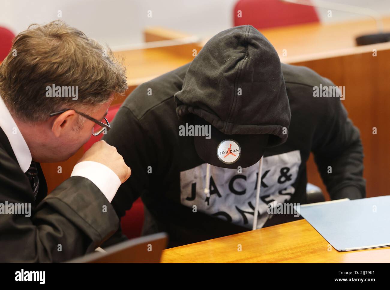 Bonn, Germany. 28th July, 2022. The defendant (r) talks to his lawyer Peter-Rene Gülpen in the regional court. The 54-year-old from Morsbach in the Upper Berg region is on trial for attempting to set his partner on fire with gasoline. (To dpa/lnw: 'Life partner doused with gasoline - trial in Bonn') Credit: Oliver Berg/dpa/Alamy Live News Stock Photo