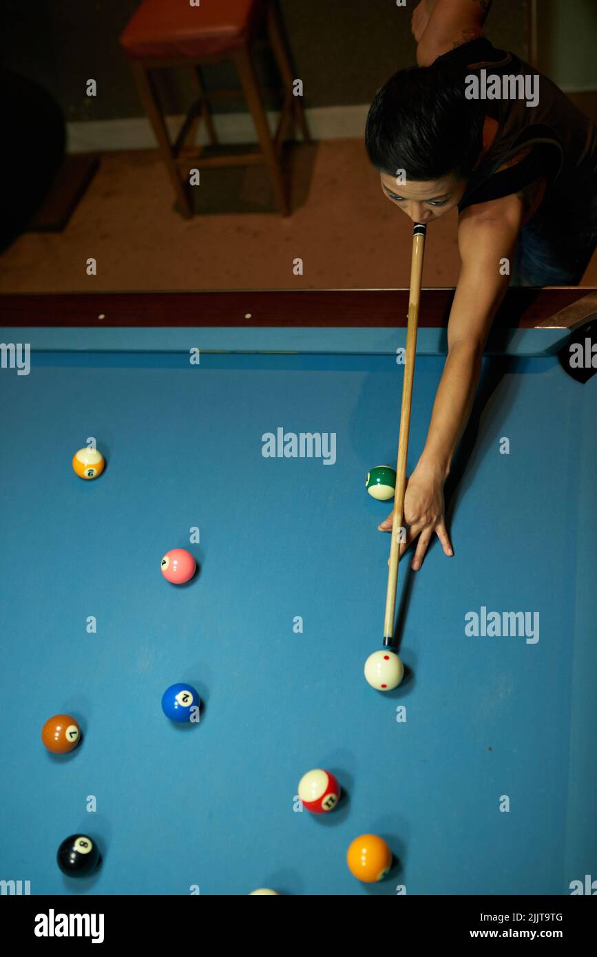 Billiard player hitting cue ball, view from above Stock Photo Alamy