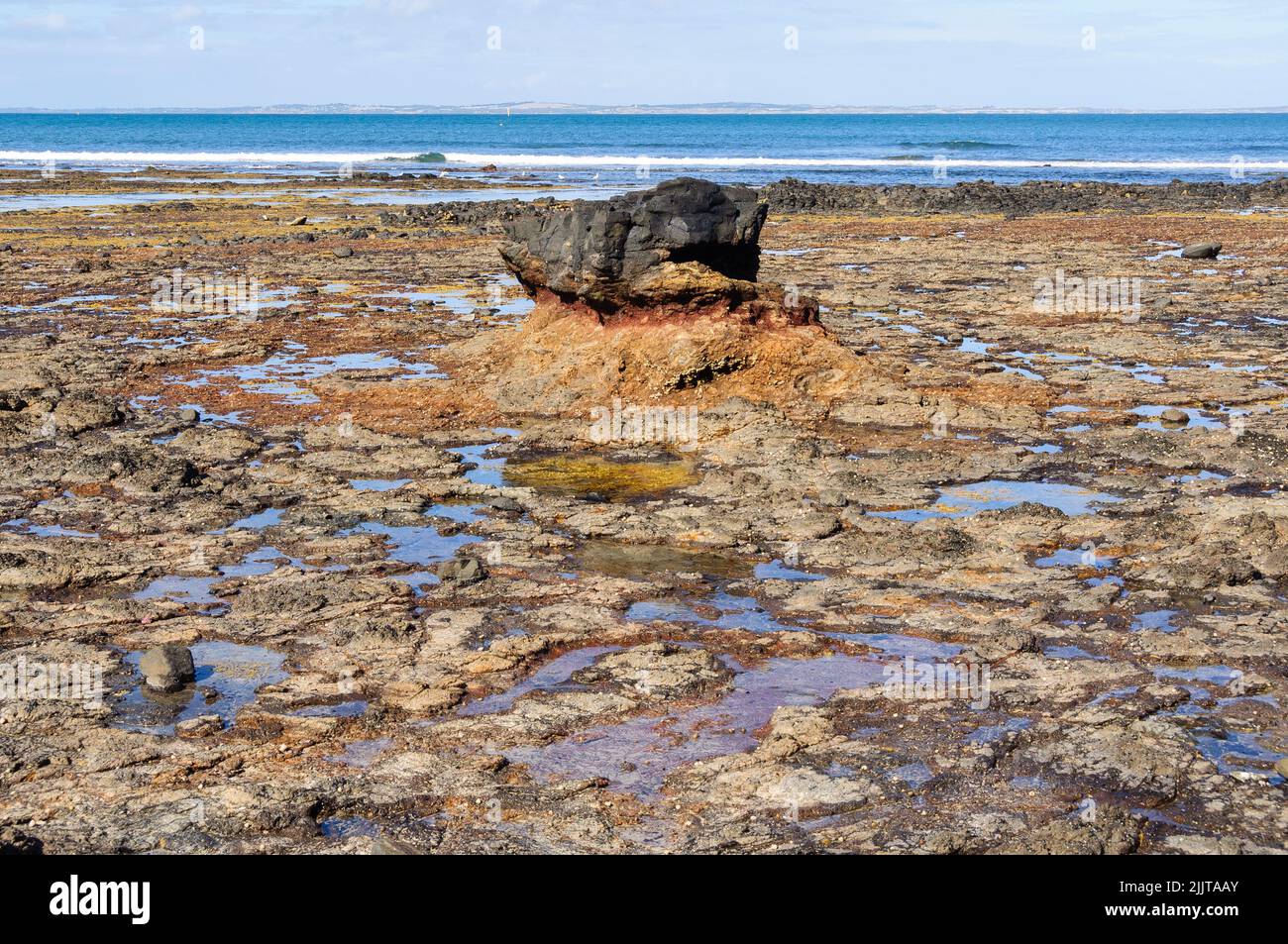Volcanic black rock on Dodds Creak Beach - Flinders, Victoria, Australia Stock Photo