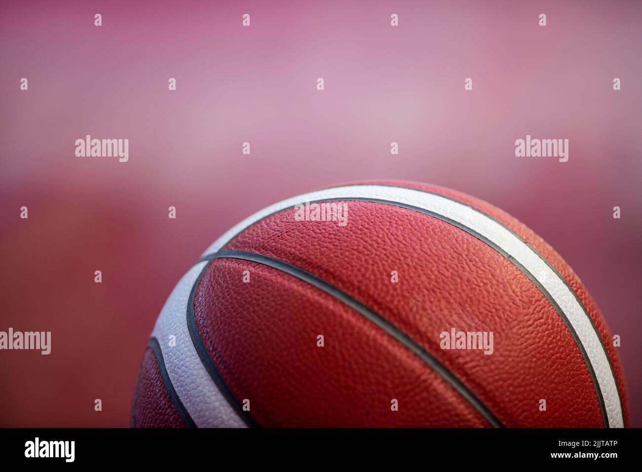 Professional basketball ball on the parquet with black background