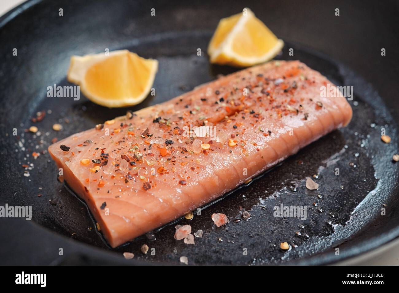 Roasted Salmon Fillet Steak In A Pan With Lemon Slices Stock Photo