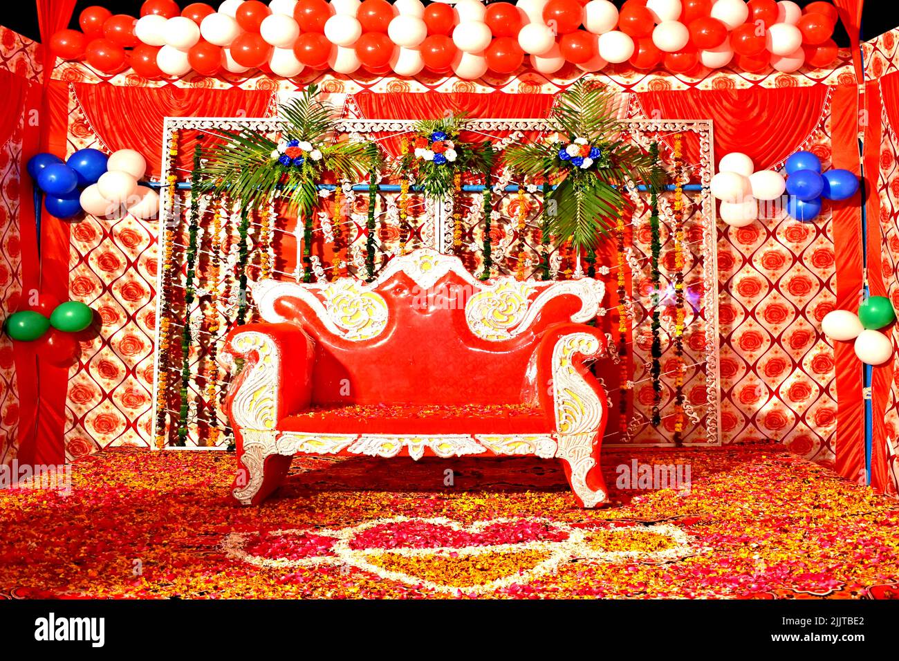 A red sofa in a decorated room in Indian-style Stock Photo