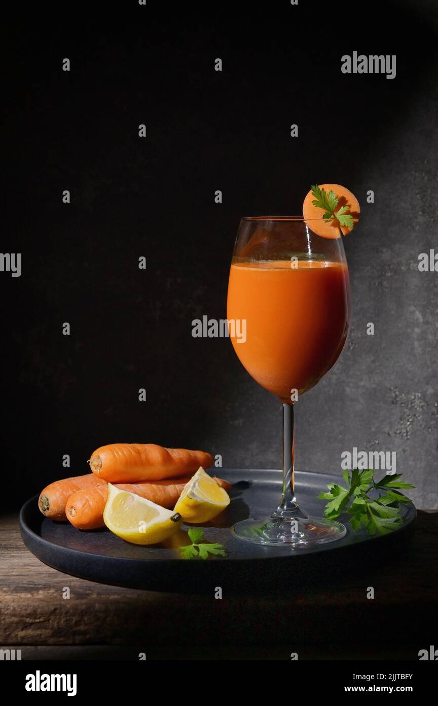 Freshly Made Carrot Juice with Lemon and Parsley Stock Photo Alamy