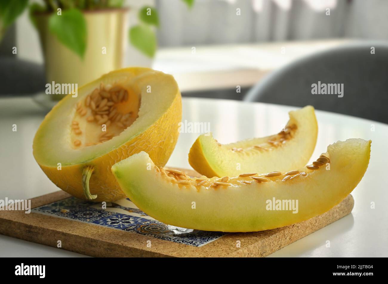 Closeup Sliced Ripe Yellow Melon on Table Stock Photo