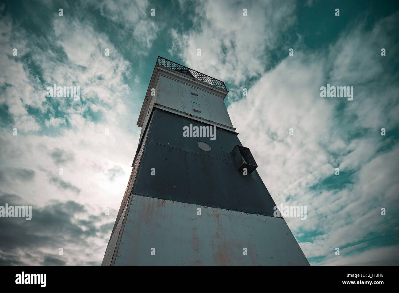 A low angle shot of the old Erie lighthouse under a dramatic cloudy sky ...