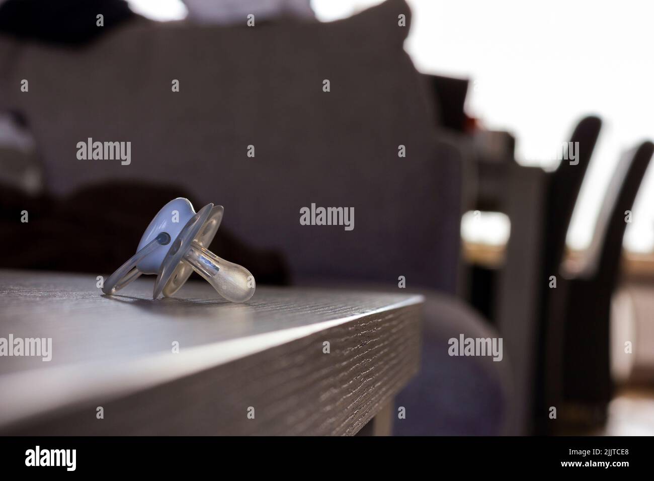 A closeup of a baby pacifier or soother on a wooden table Stock Photo