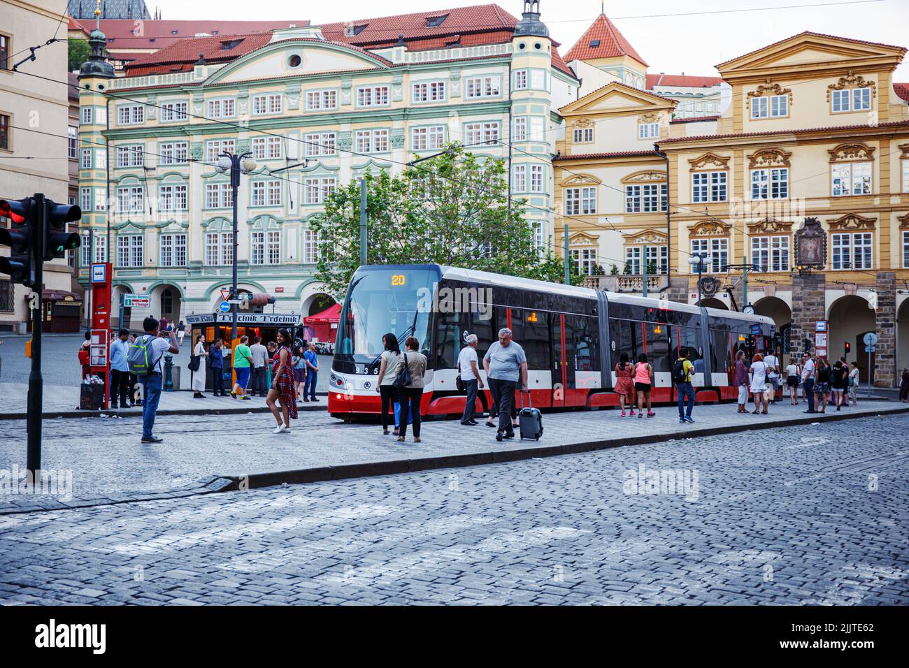 The tourists and a tram at Malostranske square stop in Prague, Czech Republic Stock Photo