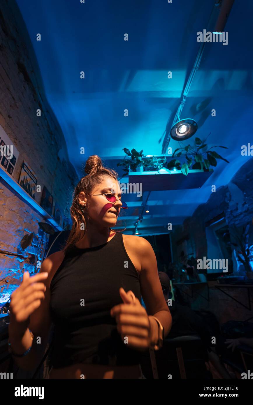 Beautiful female DJ dancing to techno in a small club Stock Photo Alamy
