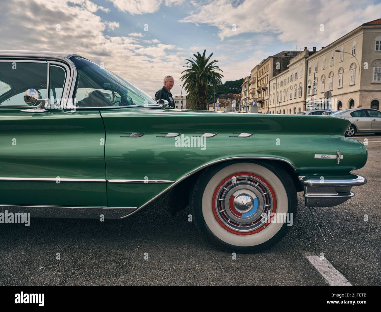 A side shot of an Oldtimer Buick Electra 1960 and his owner in Split, Croatia Stock Photo