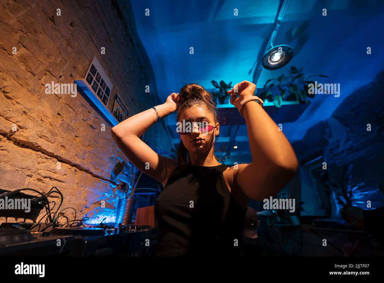 Beautiful female DJ dancing to techno in a small club Stock Photo Alamy