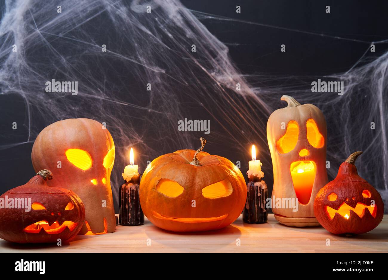 Halloween pumpkins with burning mouths, candles on orange background ...