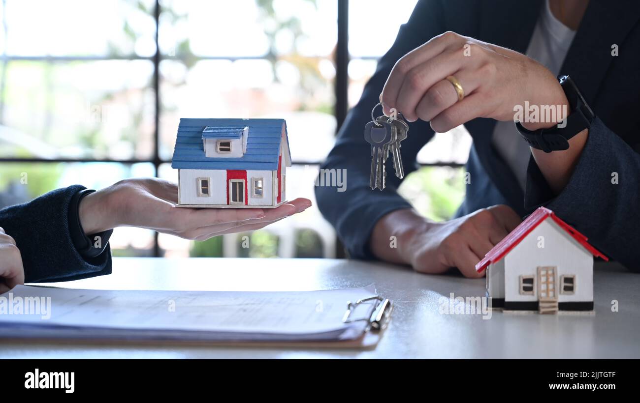 Real estate agent giving giving keys of new house to customer. Real ...