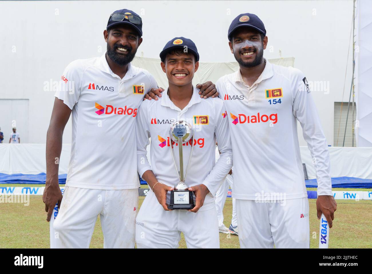 Galle, Sri Lanka. 28th July 2022. Sri Lanka's Prabath Jayasuriya (L), Dunith Wellalage (C) and Ramesh Mendis pose with the Test trophy after Sri Lanka won the 2nd test cricket match between Sri Lanka vs Pakistan at the Galle International Cricket Stadium in Galle on 28th July, 2022. Viraj Kothalwala/Alamy Live News Stock Photo