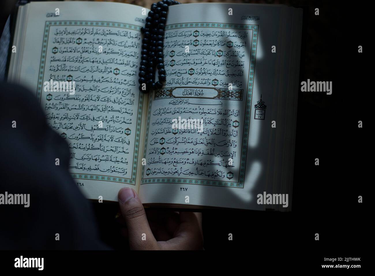 A female reading a holy book Quran in the mosque - concept of islamic education Stock Photo