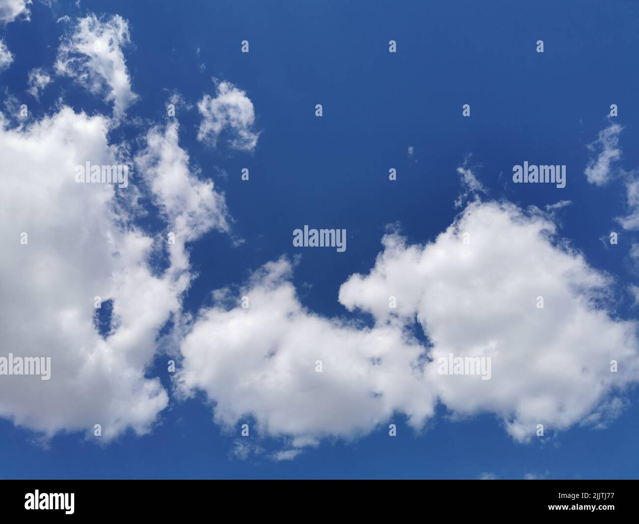 Beautiful fluffy clouds in the endless blue sky Stock Photo