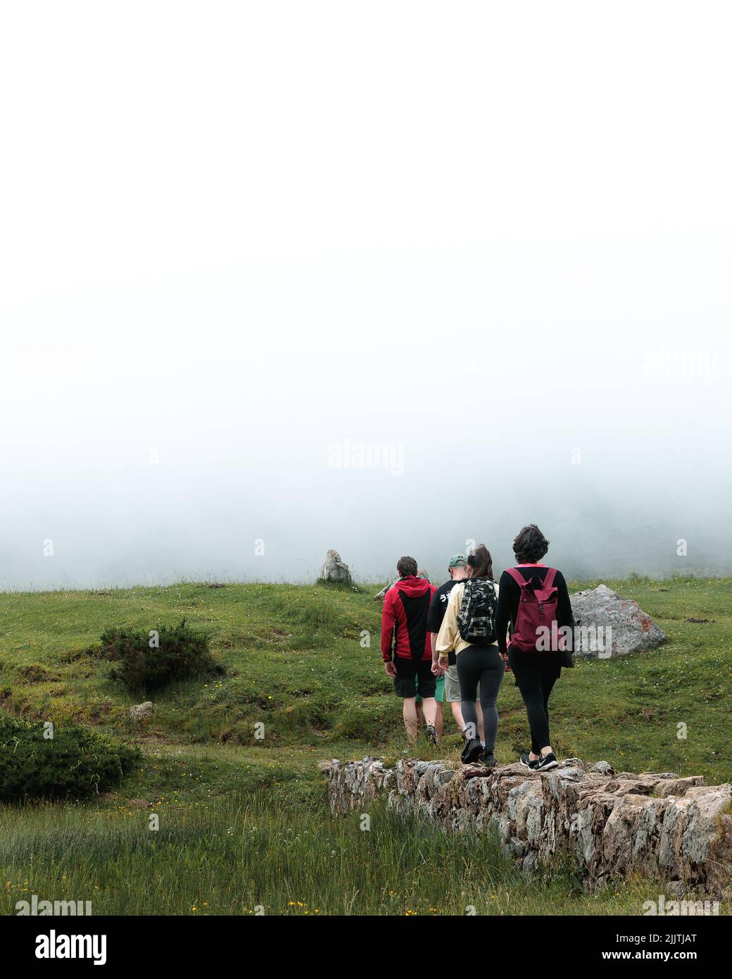 The hikers in a foggy mountains Stock Photo