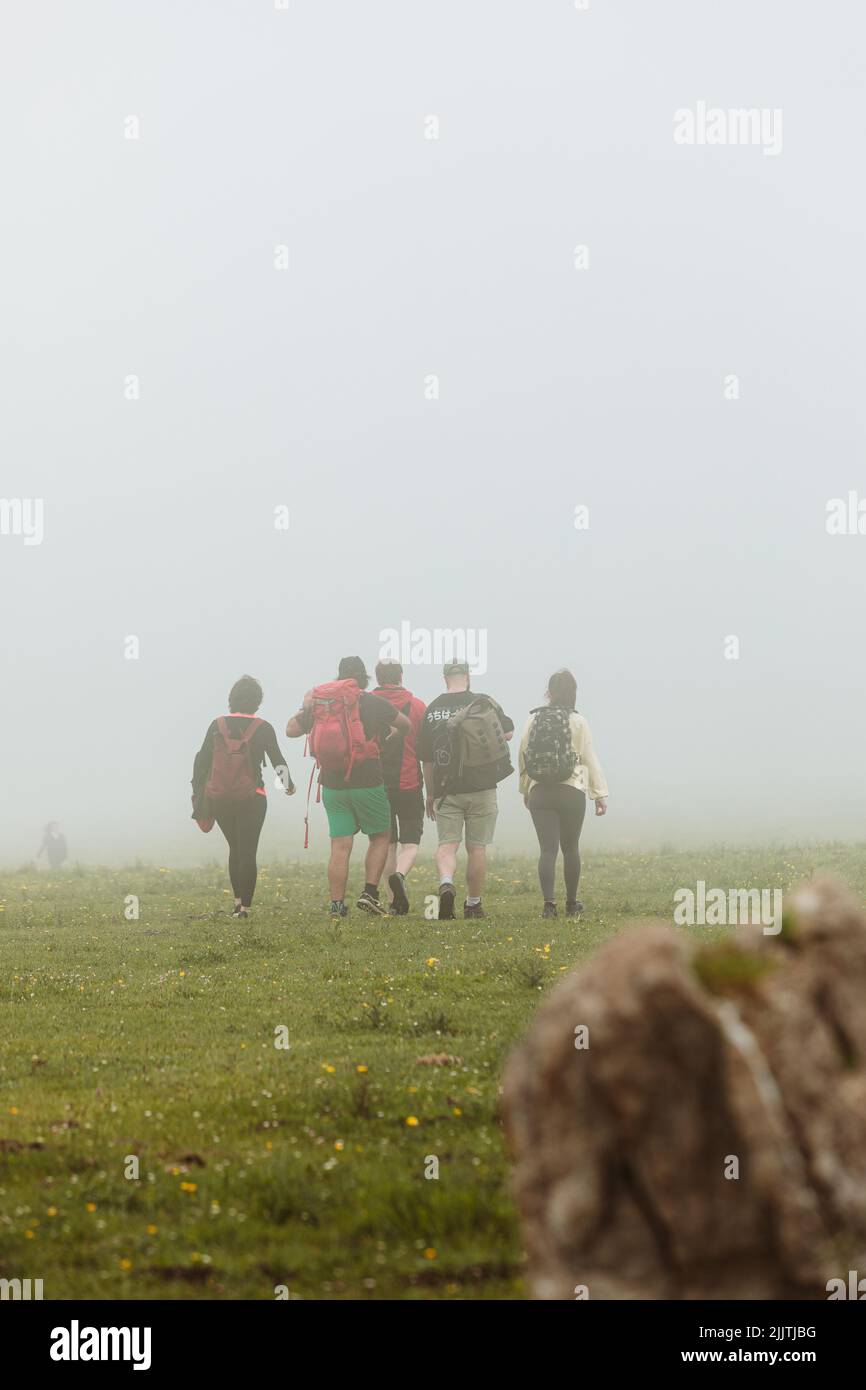 A group of hikers in a foggy mountains Stock Photo