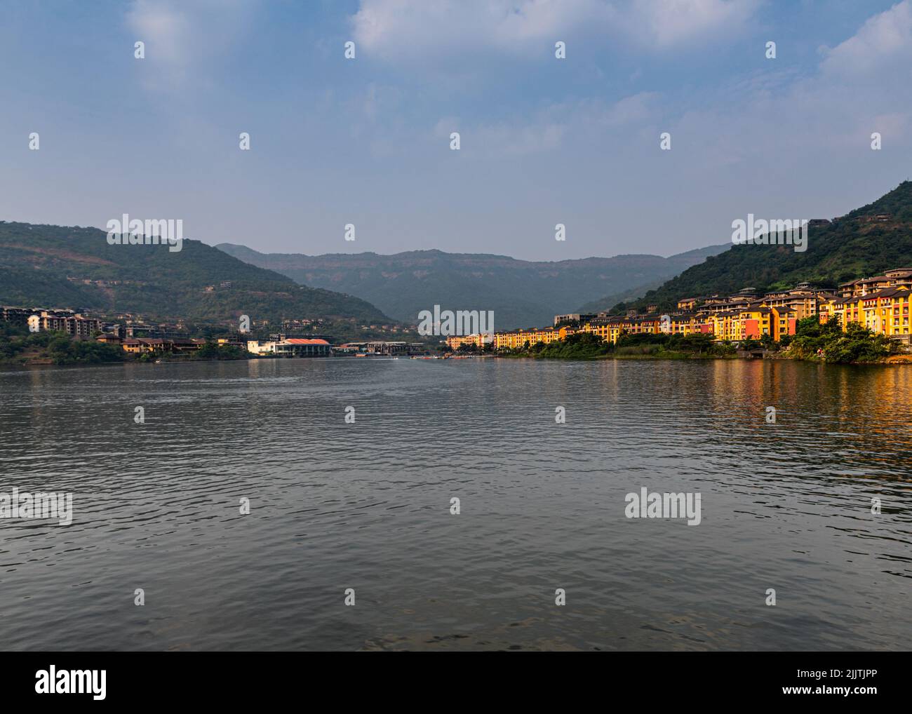 A beautiful view of the Lavasa city on the shore of the lake in India with hills in the background Stock Photo