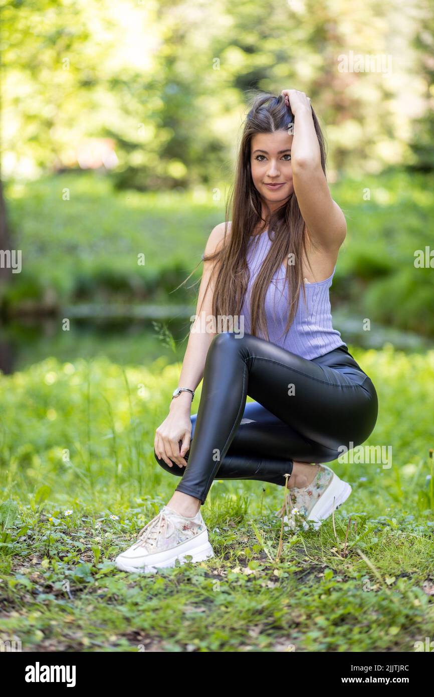 A closeup of an attractive girl posing in a park in a daylight Stock Photo