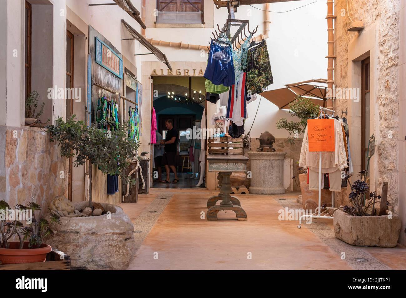 Santanyi, Spain; july 09 2022: Weekly street market in the Majorcan town of Santanyi, Spain. Stalls selling clothes and fashion with tourists strollin Stock Photo