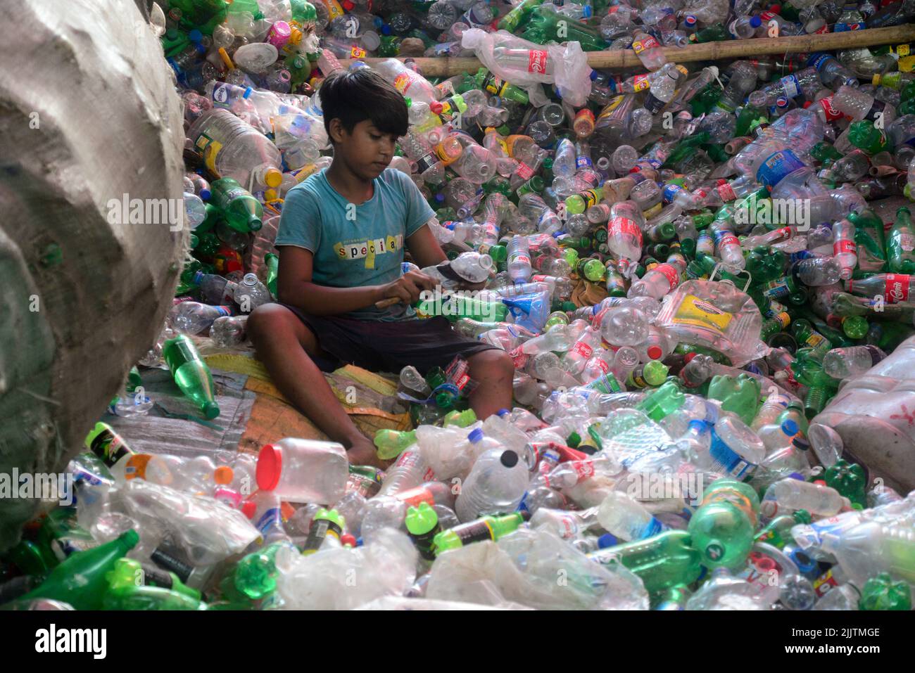 Child laborers sort through polyethylene terephthalate (PET) bottles in