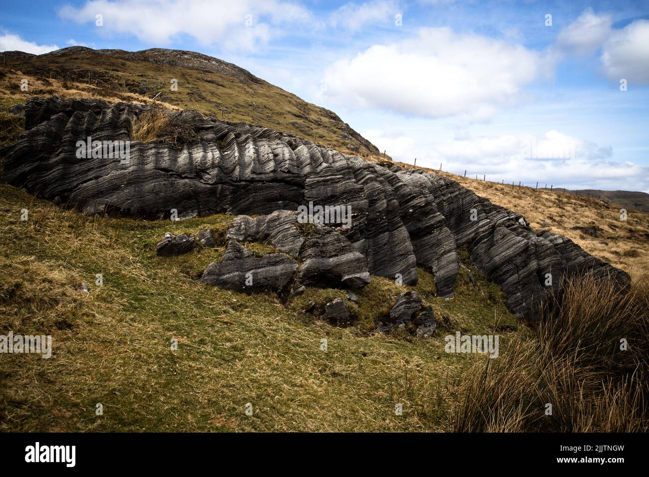An abstract rock formation on the slope of a hill Stock Photo
