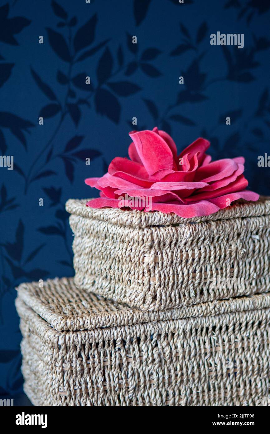 Natural gift box with a pink bow or ribbon used as decoration against a dark wall. High quality photo Stock Photo