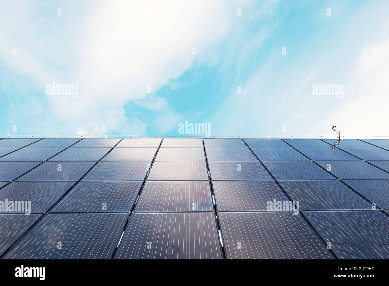 Power solar panel on blue sky background. Alternative clean green energy concept. Stock Photo