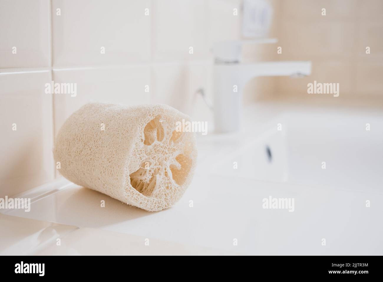 Natural loofah washcloth on the washbasin in the bathroom. Beauty, spa