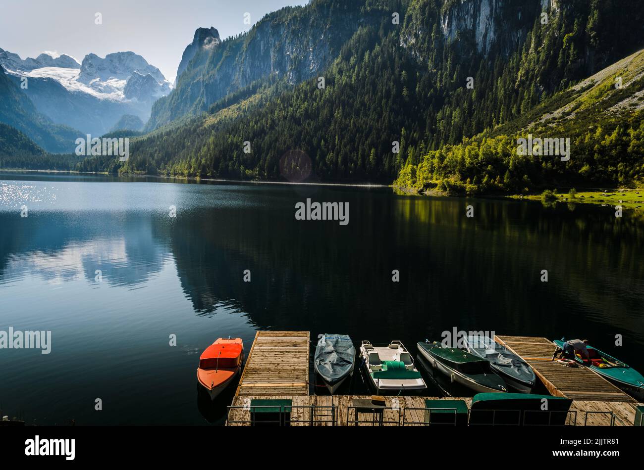A beautiful shot of boats parked in pier surrounded by landscape in ...