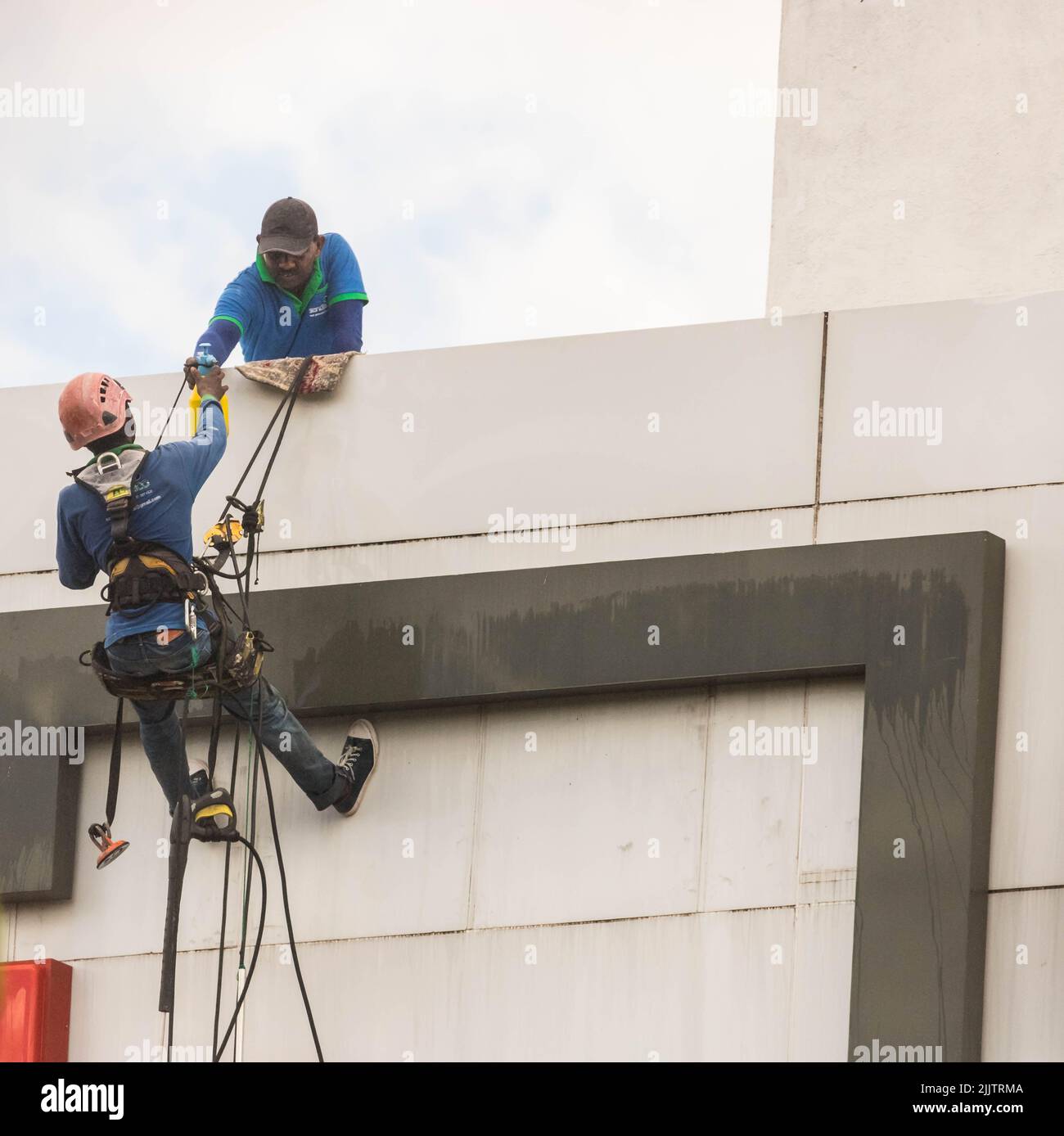 Men Cleaning a High-Rise Building Stock Photo