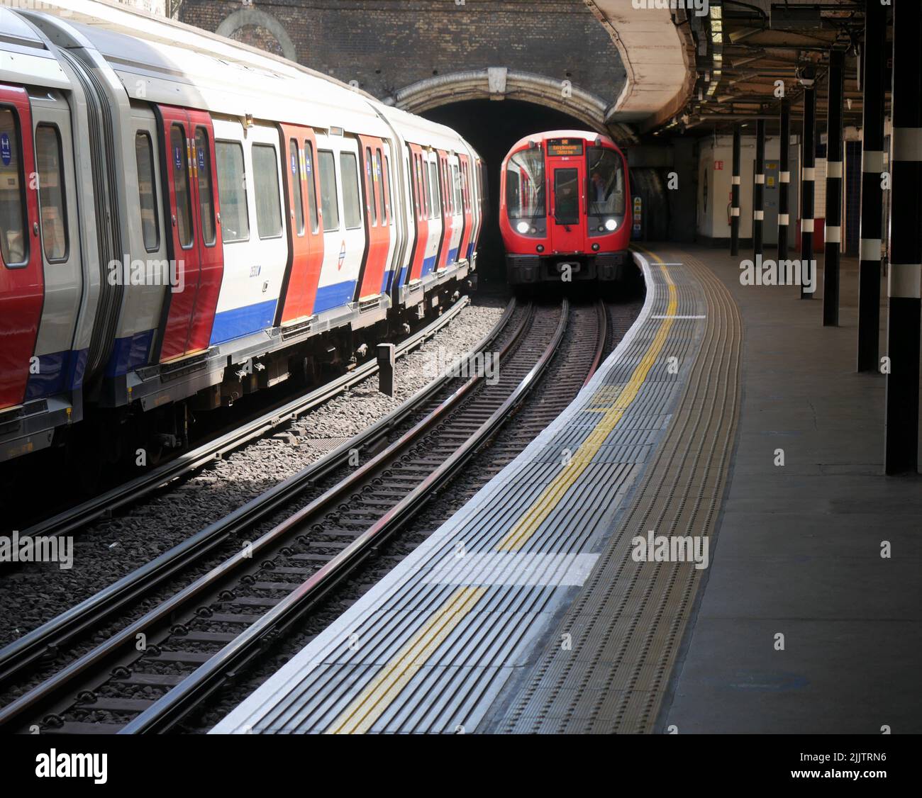 Tube train arriving at Sloane Square Station, Chelsea, London Stock Photo