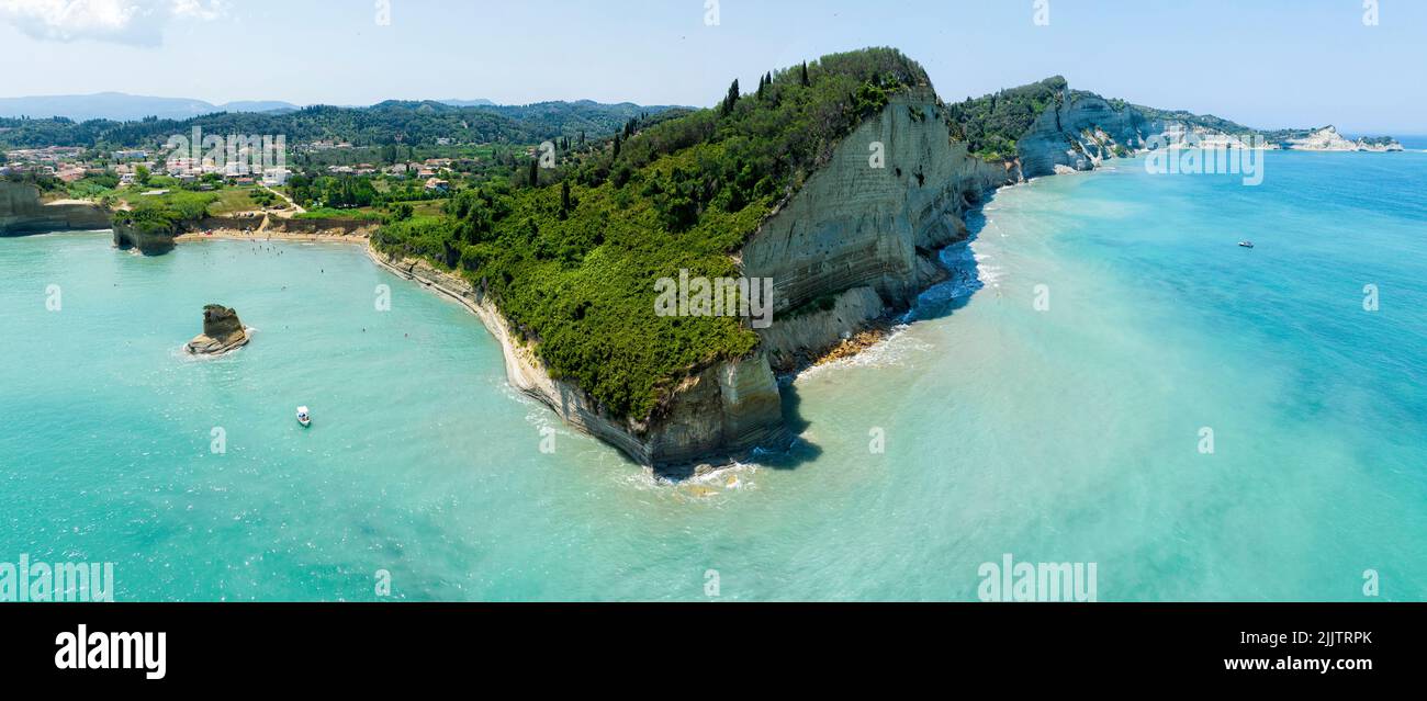 Aerial view of the cliff overlooking the sea near Apotripiti beach and of Mermaid's rock, a promontory on the crystal clear sea. Corfu island, Greece Stock Photo