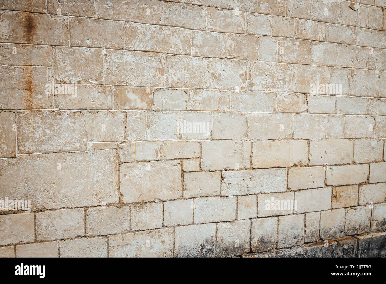 A beige old rough weathered wall Stock Photo